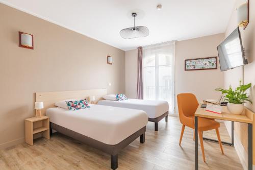 a hotel room with two beds and a desk at Appart'City Confort Agen Centre in Agen