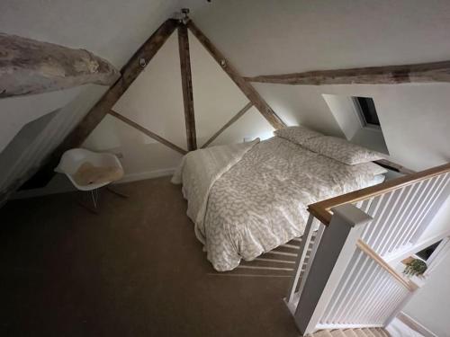 a bedroom with a large bed in a attic at Luxury 2 bed cottage in the centre of Melbourne in Melbourne