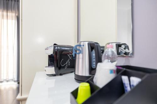 a counter top with a coffee maker and aounter sidx sidx sidx at Il Vittoria - Self Check in in Lascari