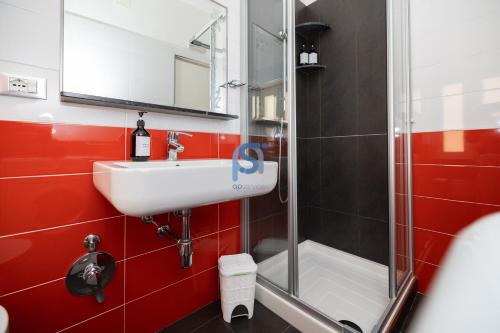 a bathroom with a sink and a shower at Il Vittoria - Self Check in in Lascari