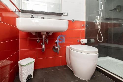 a bathroom with a white toilet and a sink at Il Vittoria - Self Check in in Lascari