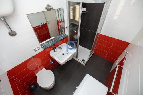 a bathroom with a white toilet and a sink at Il Vittoria - Self Check in in Lascari