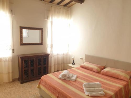 a bedroom with a bed with two towels on it at SENZATESTA 2 in Osimo