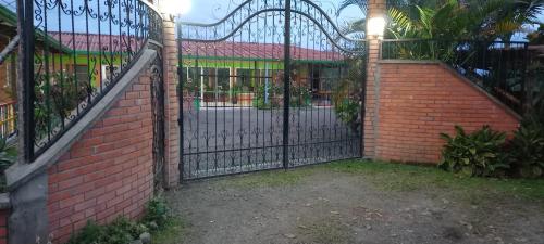 an iron gate in front of a brick building at Finca Hotel el Vergel Filandia Quindio in Filandia