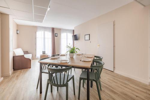 a dining room with a table and chairs at Appart'City Confort Agen Centre in Agen