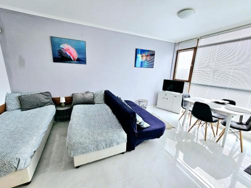 A bed or beds in a room at Studio Apartment with balcony 300m from beach