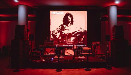 a stage with a large screen in a room at Kimpton - St Honoré Paris by IHG in Paris