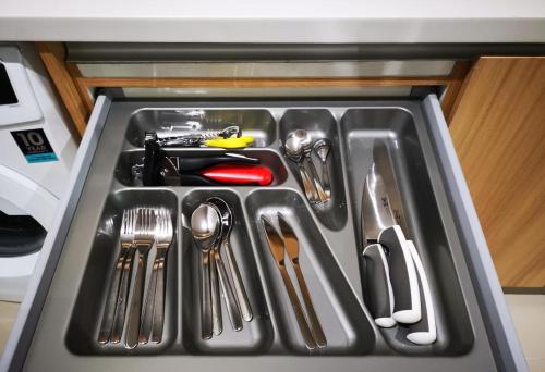 a drawer filled with utensils in a refrigerator at I-City Homestay @ Shah Alam in Shah Alam