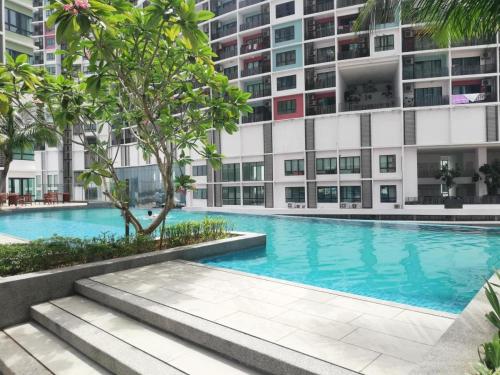 a swimming pool in front of a building at I-City Homestay @ Shah Alam in Shah Alam