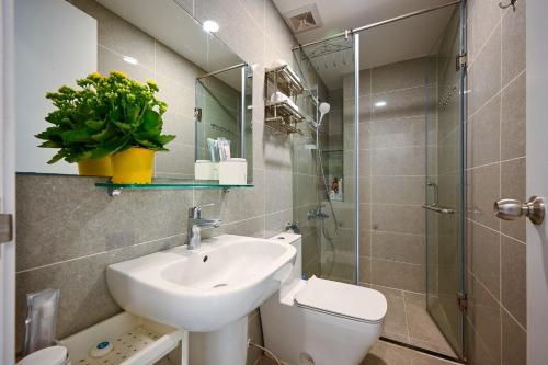 a bathroom with a sink and a toilet and a mirror at Bearshouse - Terra Royal in Ho Chi Minh City