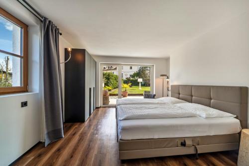 a bedroom with a large bed and a window at vinum - schlosserhaus 31 in Tesimo