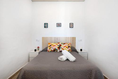 a bedroom with a bed with two pillows on it at Currimar in Conil de la Frontera