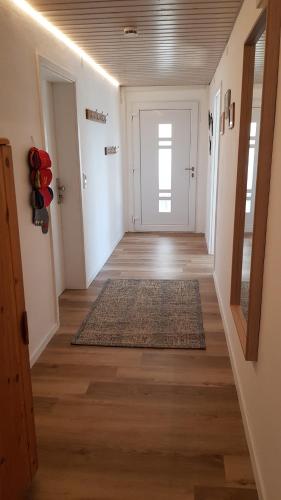 a hallway with a door and a rug on the floor at glüxnest in Bernstadt