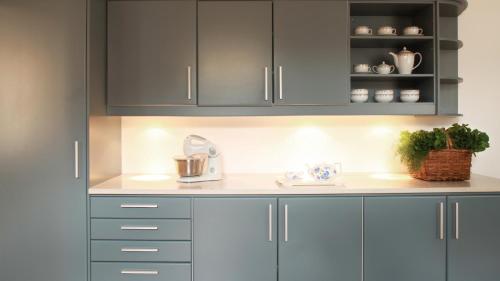 a kitchen with gray cabinets and a counter top at Quinta das Malvas - Quinta de Santa Luzia in Funchal