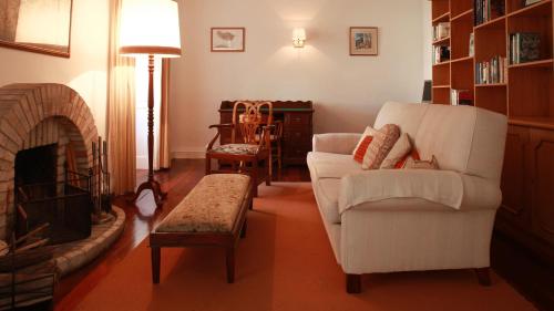 a living room with a couch and a fireplace at Quinta das Malvas - Quinta de Santa Luzia in Funchal