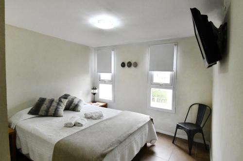 a bedroom with a bed with towels on it at O2 Hotel Villa Gesell in Villa Gesell