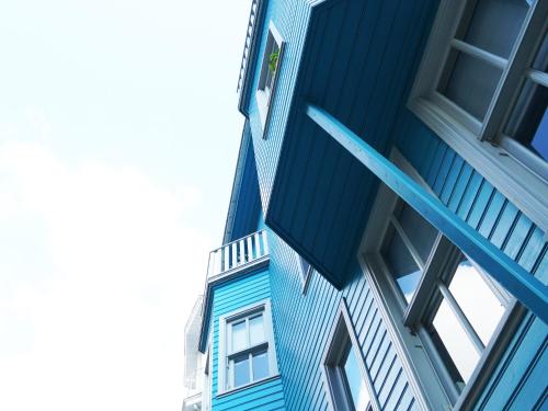 a blue building with a window on the side of it at Tilas - Rooms in 19th Century Wooden Townhouse,Kadikoy in Istanbul