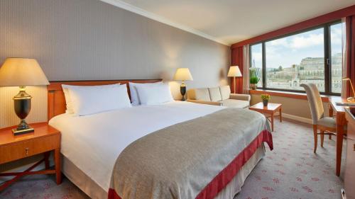 a hotel room with a large bed and a window at InterContinental Budapest by IHG in Budapest