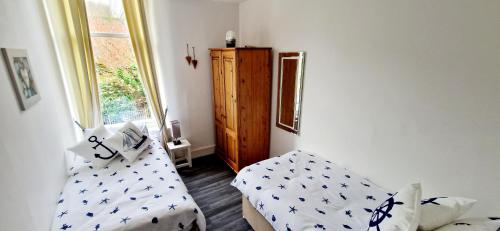 a living room with a couch and a window at Entire Apartment, Rothesay, Isle of Bute in Rothesay