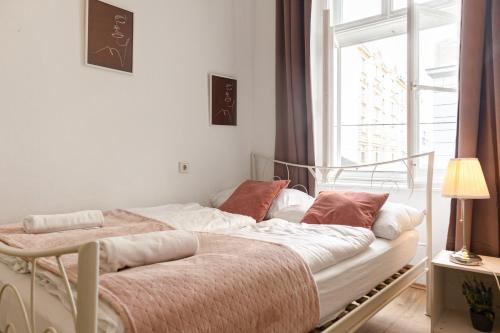 a bed in a room with a window at Comfortable 2BR Apt Central and Well Connected in Vienna