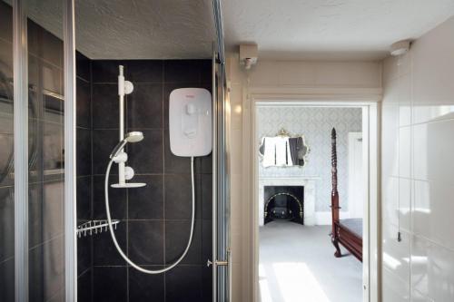 a bathroom with a shower in a room at Elm Grove Country House in Tenby