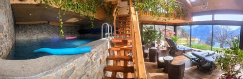 a swimming pool with a slide in a house at L Ame et Son du Coeur in Dorénaz