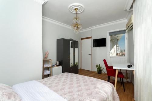 a bedroom with a bed and a desk and a table at 8 Rooms House in Balcova
