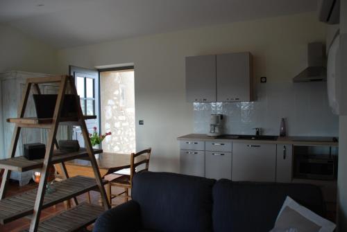 a living room with a couch and a kitchen at Bastide Saint Maurin in Ansouis