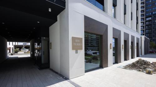 a building with a sign on the side of it at Terra Luxe Residences in Sajmište