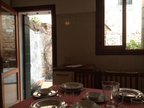 a table with plates and dishes on a table at Appartamento Corte Zappa in Venice