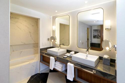 a bathroom with two sinks and a large mirror at Culiacan Marriott Hotel in Culiacán