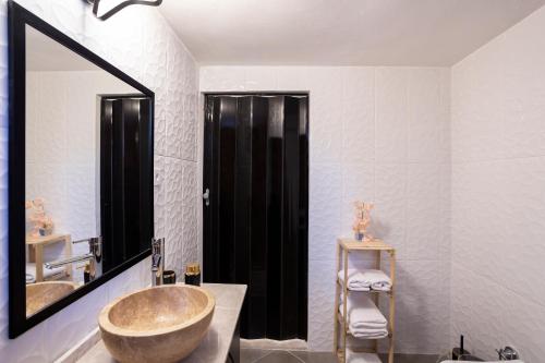 a bathroom with a large sink and a large mirror at 8 Rooms House in Balcova