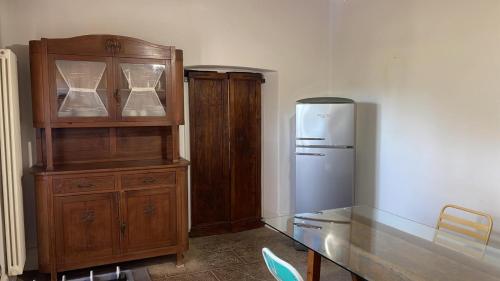 eine Küche mit einem Holzschrank und einem Kühlschrank in der Unterkunft CASALE LA BANDITA in La Bandita