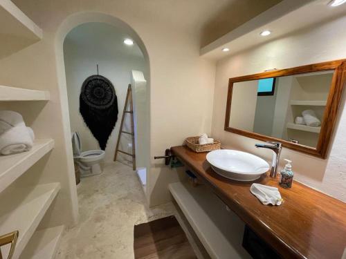 a bathroom with a sink and a mirror at Casa Zaba in Tulum