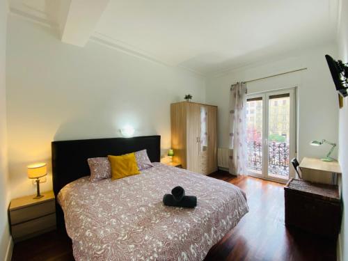 um quarto com uma cama com um chapéu preto em La plaza apartment em San Sebastián