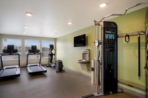 a gym with treadmills and cardio equipment in a room at WoodSpring Suites Grand Rapids Kentwood in Grand Rapids