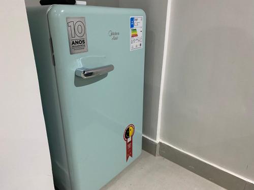 an old blue refrigerator with a sticker on it at Ház Portuguesa in Rio de Janeiro