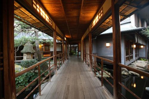a hallway of a building with a wooden walkway at Yoyokaku in Karatsu