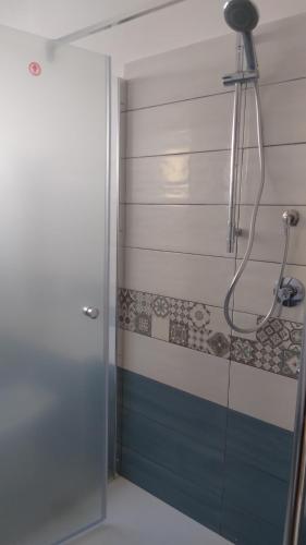 La salle de bains est pourvue d'une douche avec une porte en verre. dans l'établissement Casa Gaia, à Cala Gonone