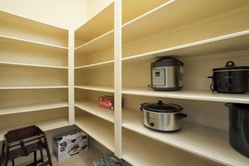 a kitchen with shelves with pots and pans on them at Bedroom with 3.5-Bathroom near Golf Course! in Cypress