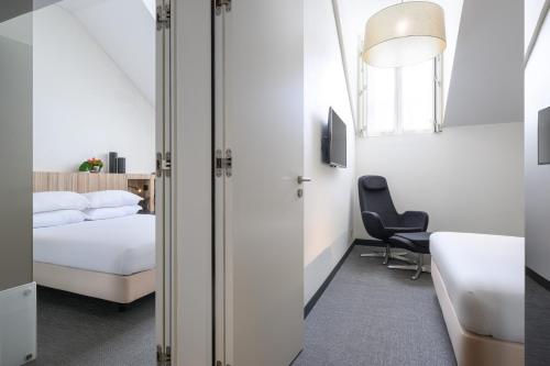 a bedroom with a bed and a desk and a chair at Inspira Liberdade Boutique Hotel in Lisbon