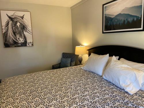 a hotel room with a bed and a chair at Franconia Inn in Franconia