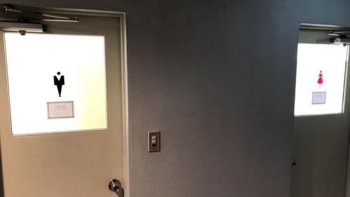 a door with a picture of a man in a suit on it at Kagetsu Ryokan in Shizuoka