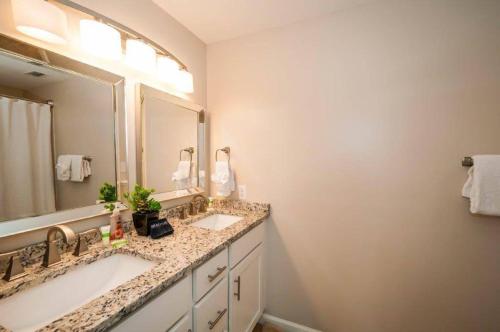 a bathroom with two sinks and a large mirror at Majestic Sun 1108B in Destin