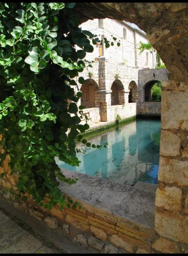 a pool of water in front of a building at Luxury Apartment Flora, Stari Grad, Hvar Island in Stari Grad