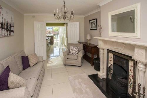 a living room with a couch and a fireplace at Sleepy Rock in Dungarvan