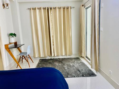a living room with a blue couch and a window at Private Room near Istanbul Airport 2 in Arnavutköy