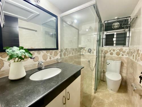 a bathroom with a sink and a toilet and a glass shower at Private Room near Istanbul Airport 2 in Arnavutköy