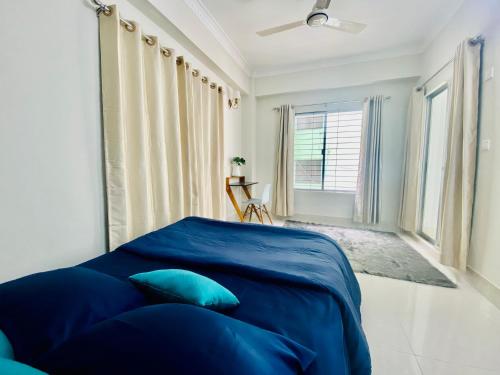 a bedroom with a blue bed and a window at Private Room near Istanbul Airport 2 in Arnavutköy