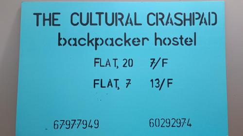 a sign that reads the cultural catalyst backpacker hostel at The Cultural Crashpad - 康乃馨旅館 in Hong Kong